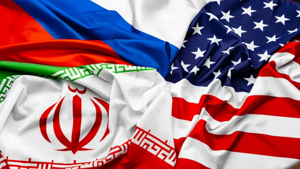 Top-down view of the Iranian, United States, and Russian flags on rippled fabric.